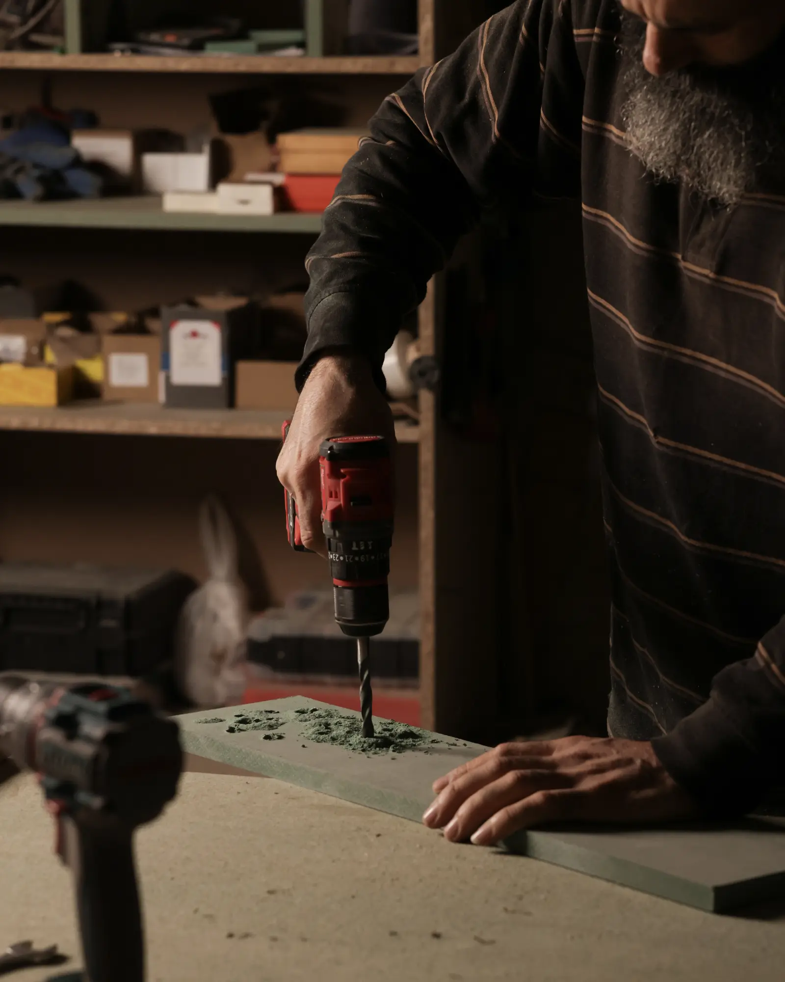 The master carpenter's hands at work on the fluted panel